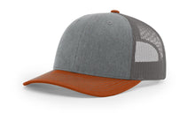 Richardson 112 Trucker Hat in Heather Grey, Charcoal, and Dark Orange with structured front, mesh back, and snapback closure.