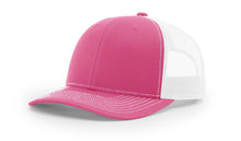 Richardson 112 Trucker Hat in Hot Pink and White with structured front, mesh back, pre-curved visor, and adjustable snapback closure.