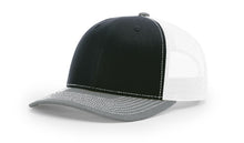 Richardson 112 Trucker Hat in Black, White and Heather Grey with structured front, mesh back, pre-curved visor, and adjustable snapback closure.