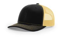 Richardson 112 trucker hat in black and Vegas gold, combining classic fit with bold contrast—great for custom embroidery.