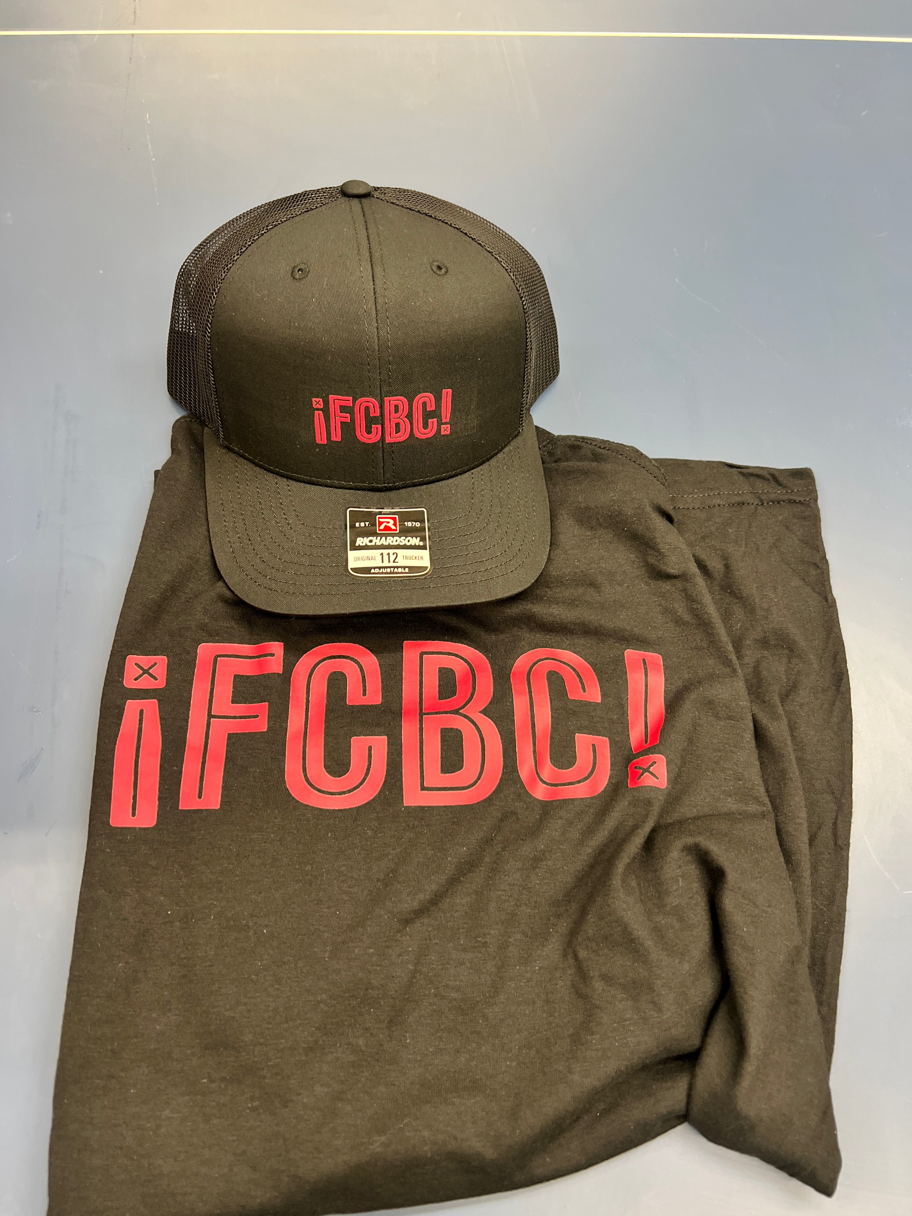 FCBC embroidered black trucker cap and screen printed black tee with red logo, custom set by Presto Embroidery