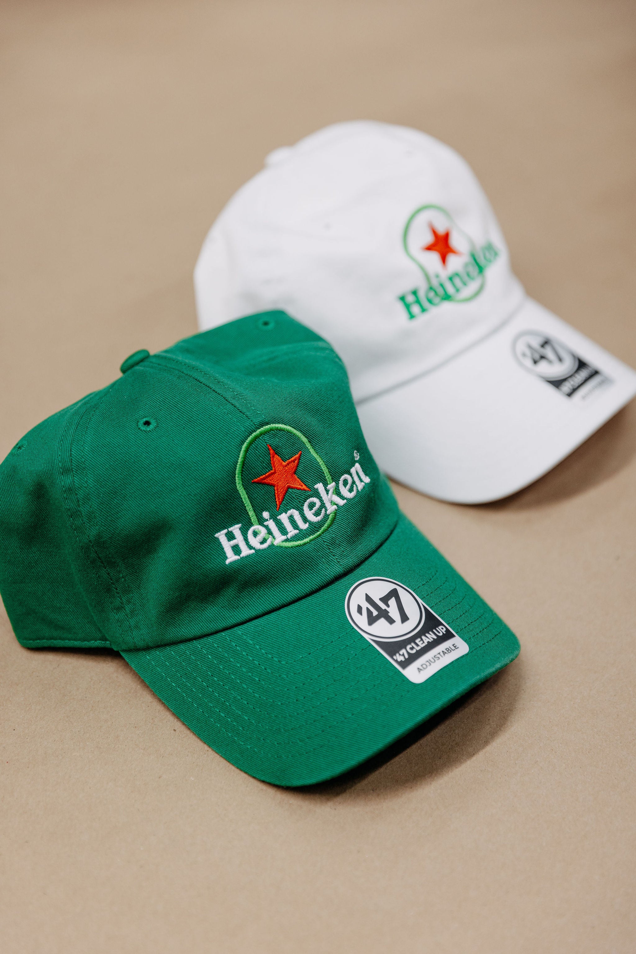 Heineken green and white embroidered 47 Brand baseball caps with classic Heineken star logo, custom stitched in pairs by Presto Embroidery for Heineken brand activations