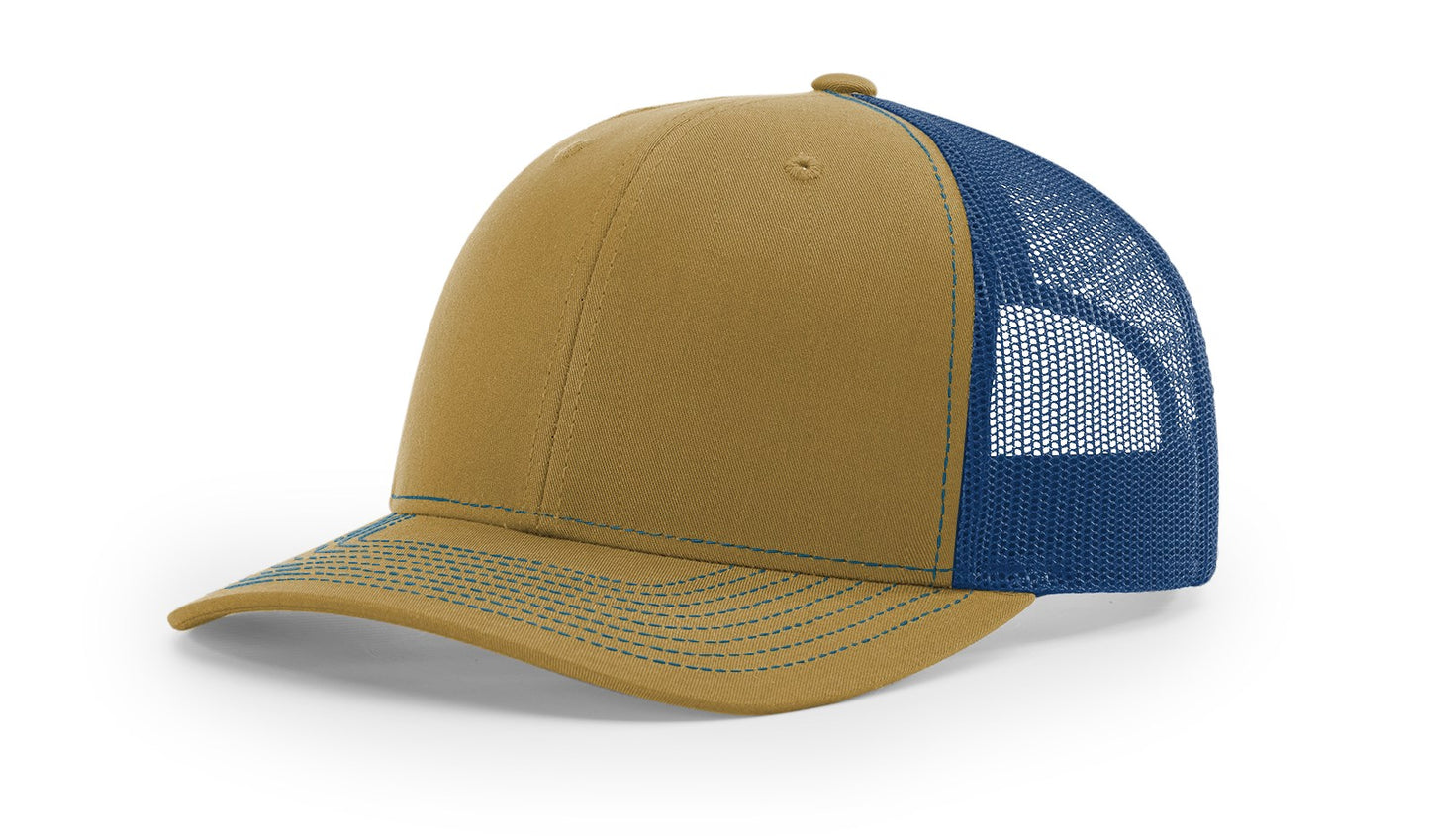 Richardson 112 Trucker Hat in Biscuit and True Blue with structured front, mesh back, pre-curved visor, and adjustable snapback closure.