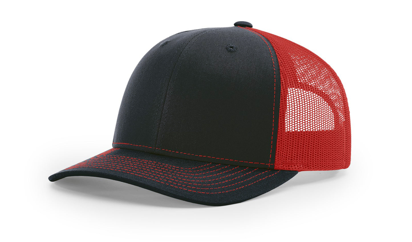 Richardson 112 Trucker Hat in Navy and Red with structured front, mesh back, pre-curved visor, and adjustable snapback closure.