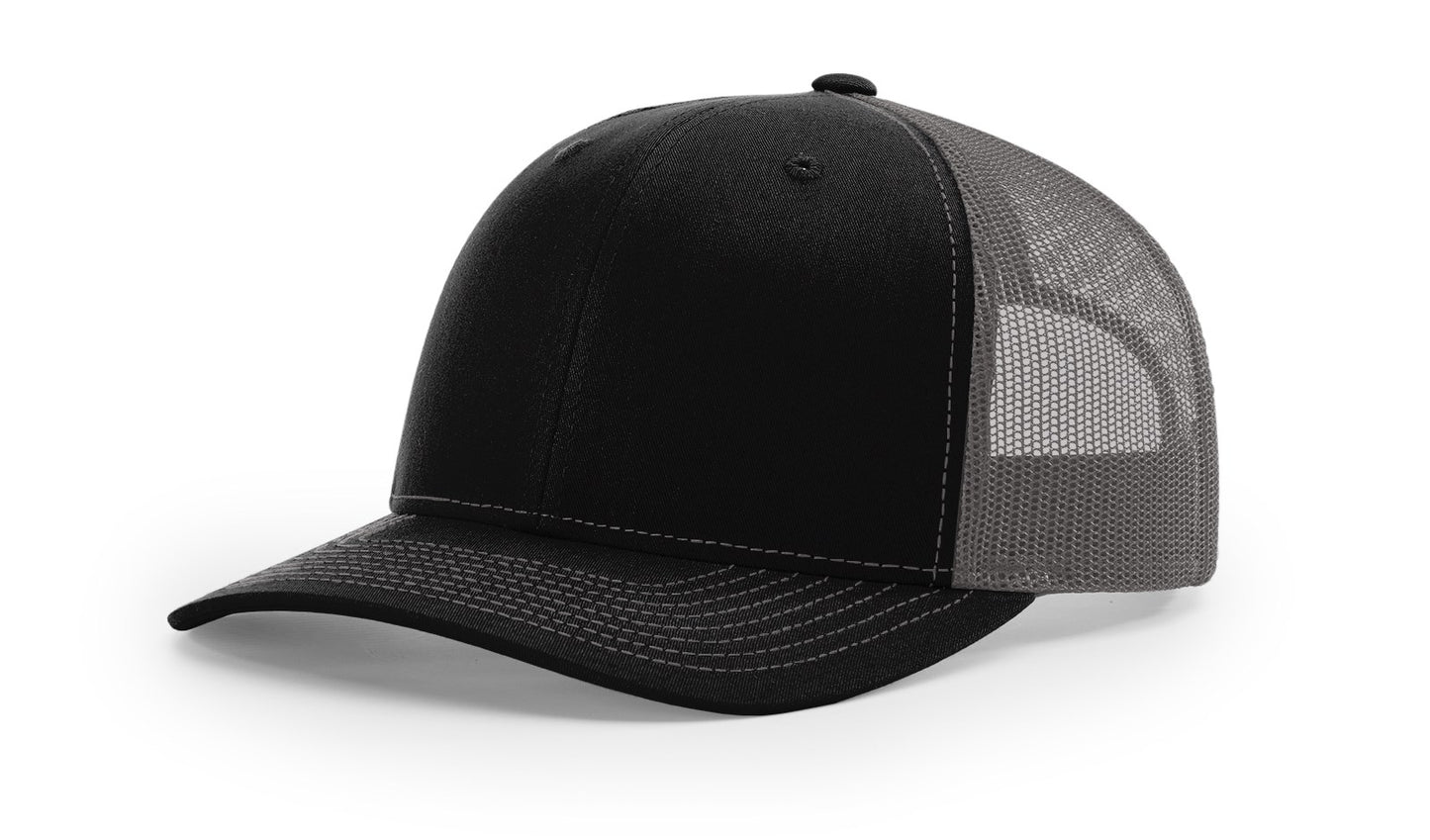 Richardson 112 trucker hat in black and charcoal grey, featuring mesh back and structured front—ideal for custom embroidery.